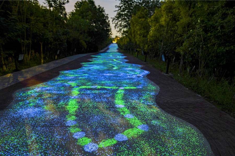 Fluorescent footpath glows under the night sky in Chongqing