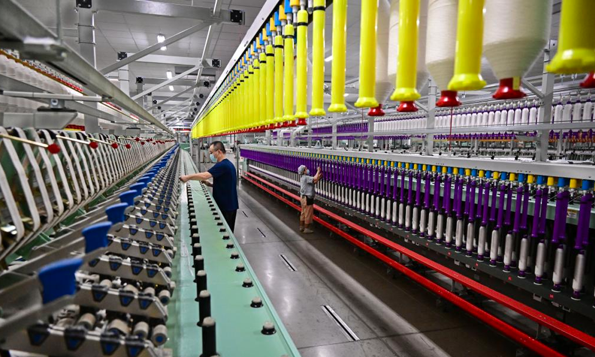 An employee of a smart spinning enterprise works on a fully automatic roving production line in Jimo District of Qingdao City, east China's Shandong Province, on March 25, 2025. Photo: Xinhua
