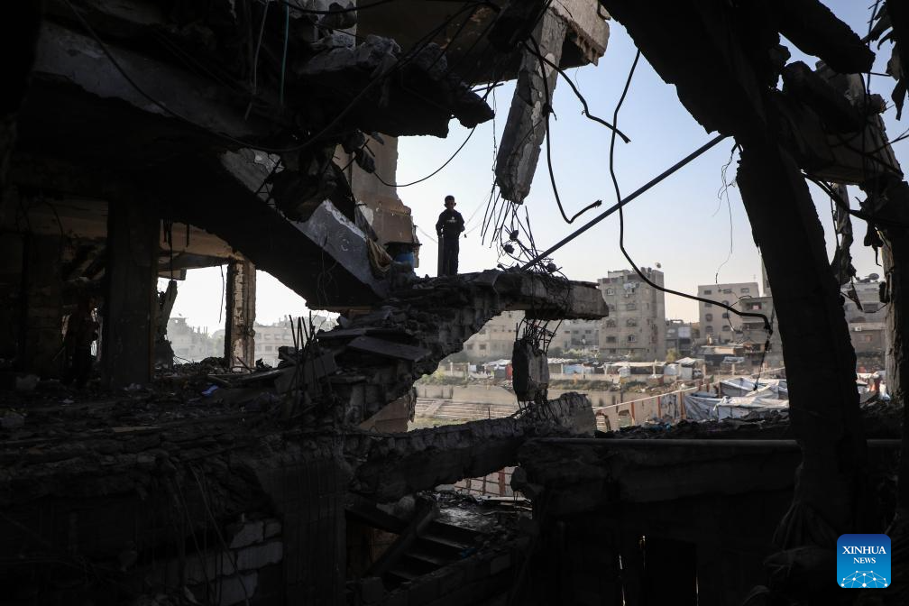 Palestinians inspect destroyed houses after Israeli airstrikes in Gaza City